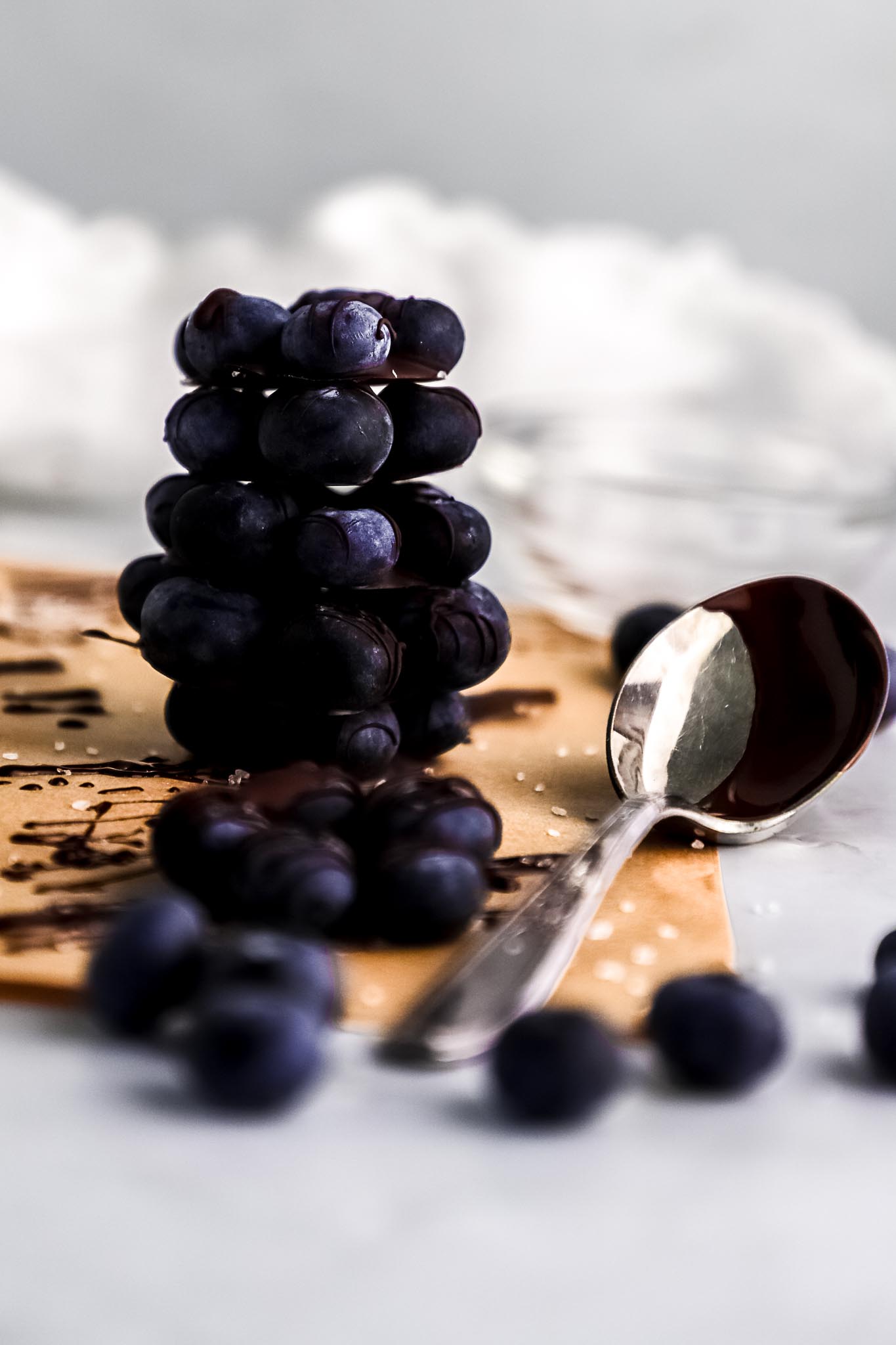 chocolate-covered-blueberry-flowers-arranged-on-parchment-paper